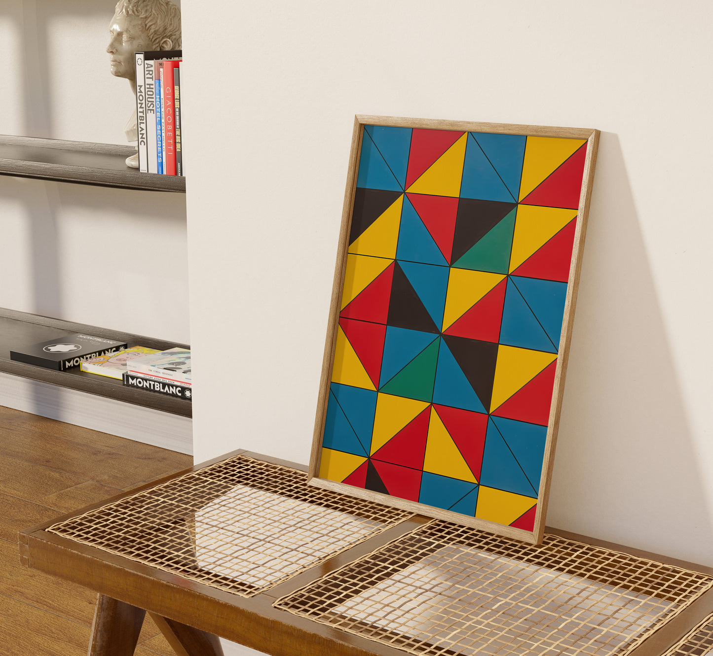 Colorful geometric artwork leaning against a wall on a wooden table with a decorative tray.
