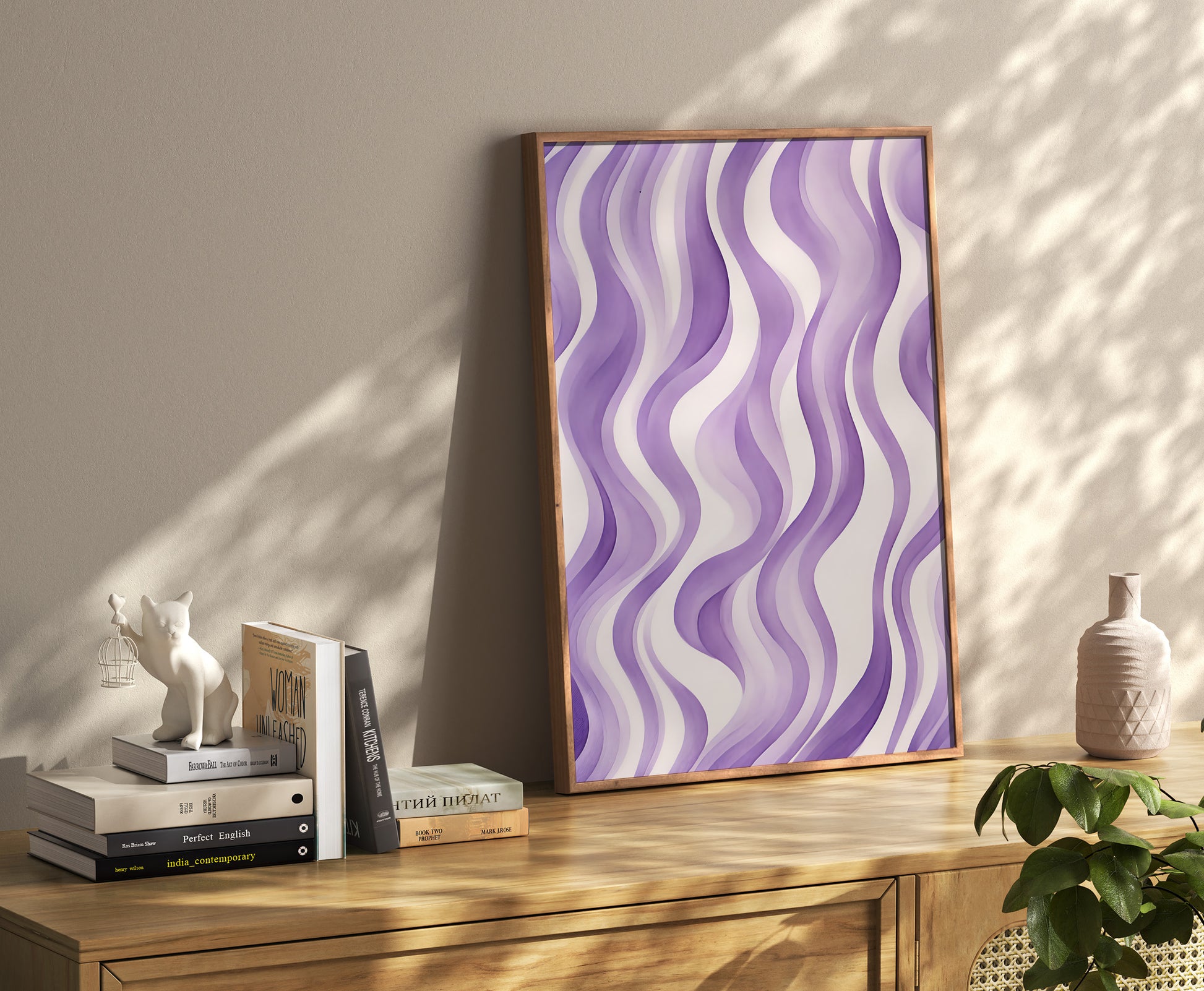 Abstract wavy purple art on a canvas leaning against a wall beside books and decorative items.