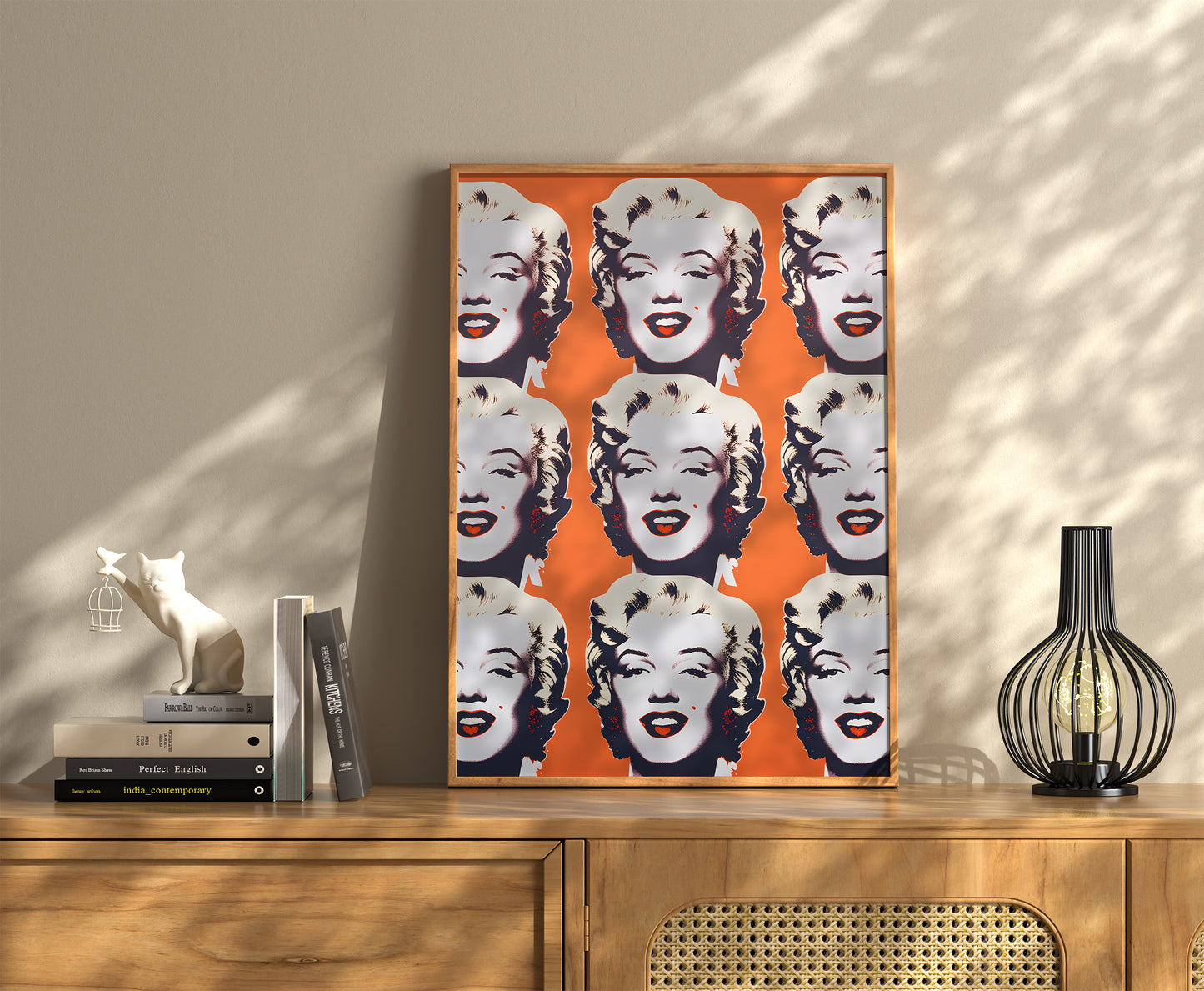 Pop art style artwork of a celebrity with multiple faces on a wall above a sideboard.