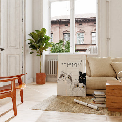 Modern living room with a cozy beige sofa, wooden furniture, and a playful cat illustration on canvas.