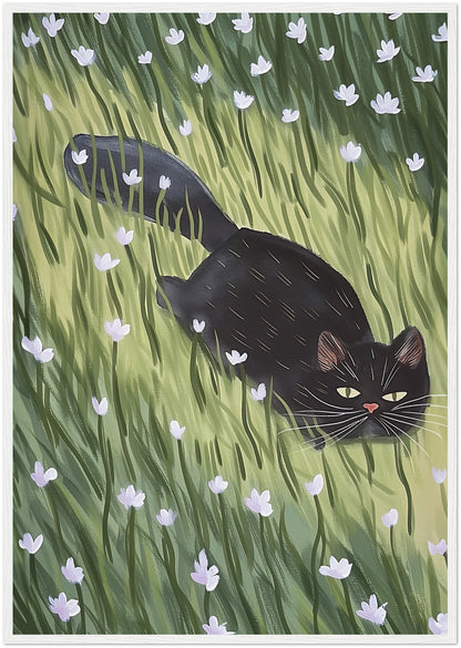 A painting of a black cat walking through a green field with white flowers, framed in wood.
