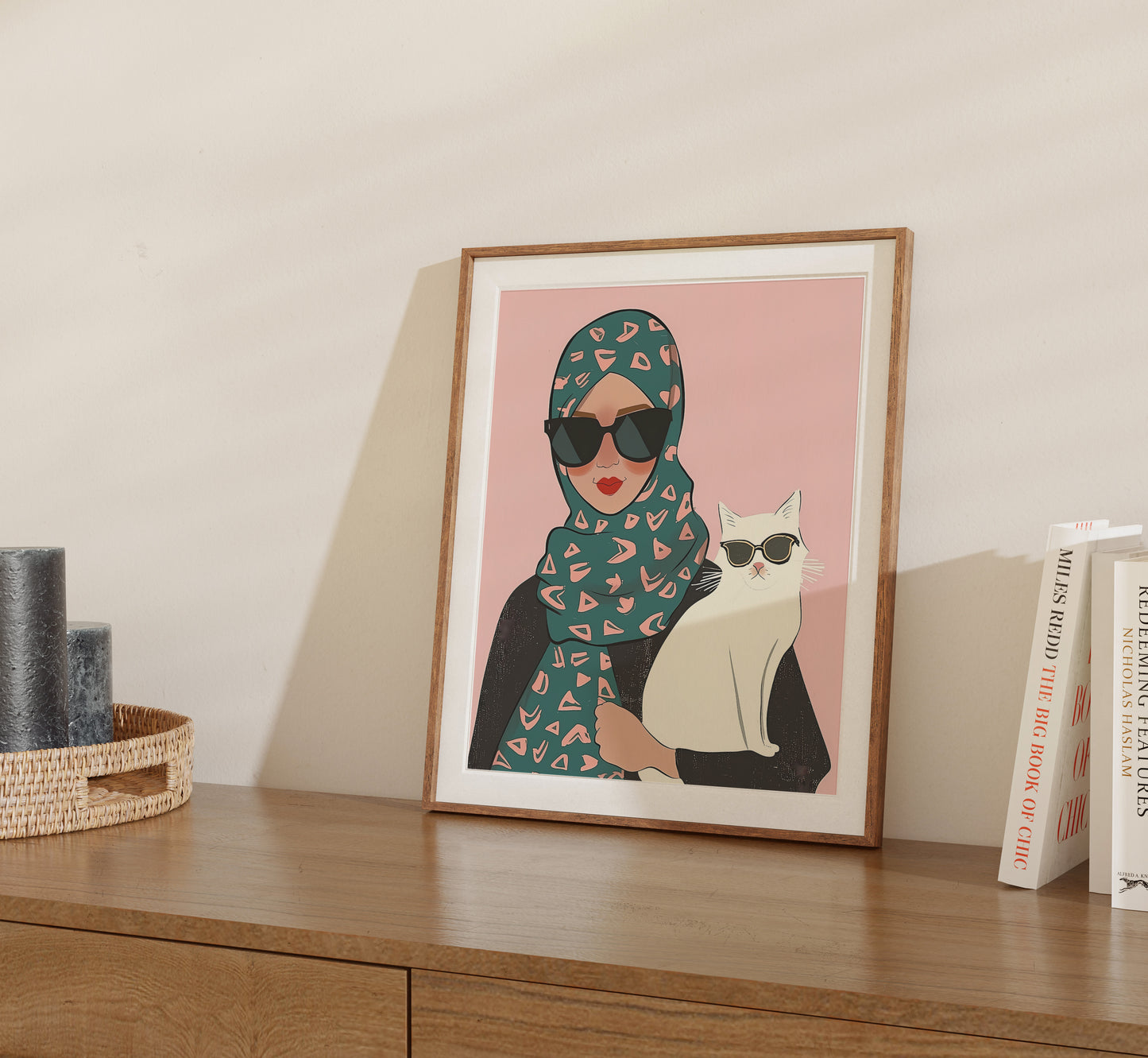 Illustration of a woman in a hijab and sunglasses with a cat wearing sunglasses in a frame.