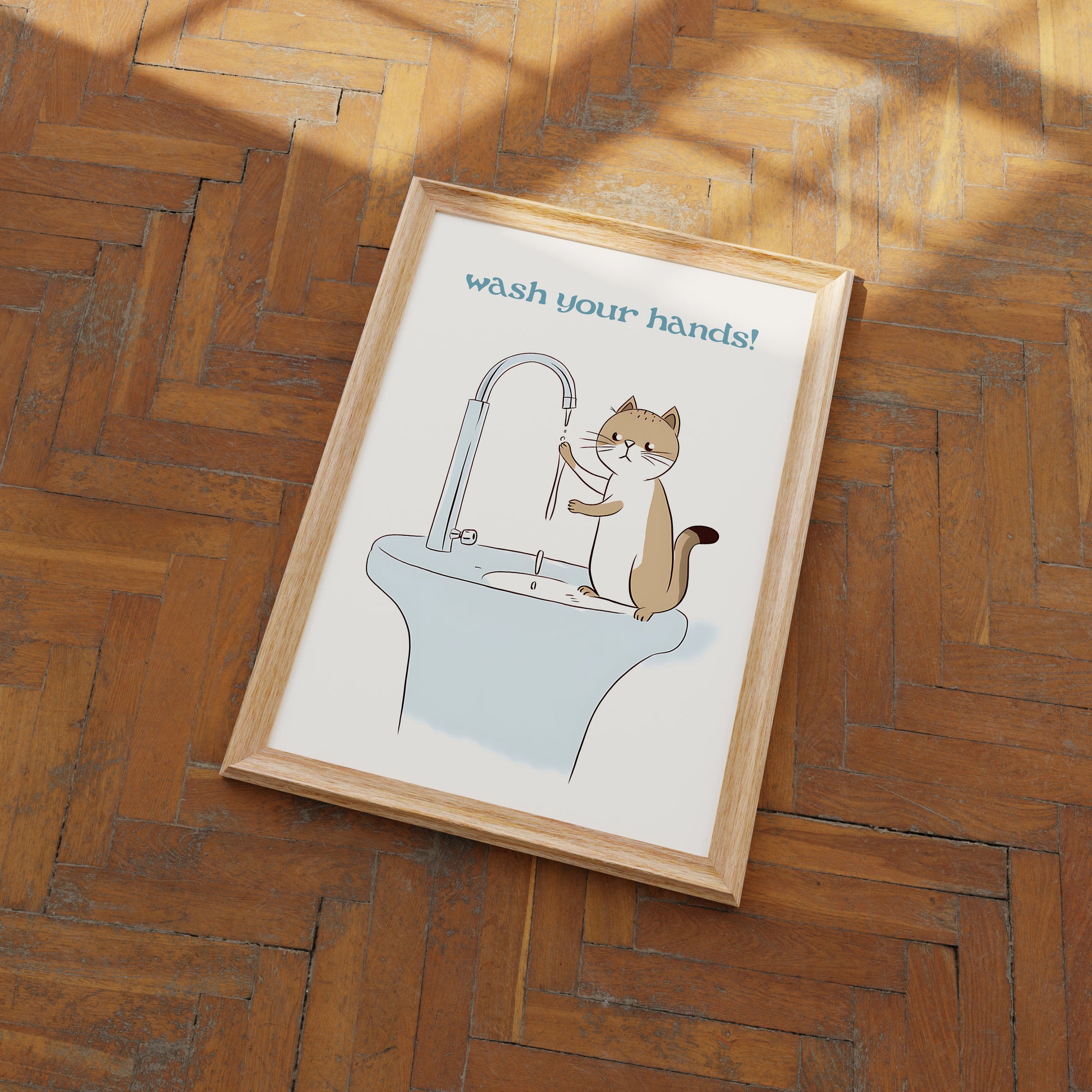 Illustration of a cat washing its paws over a sink with text "wash your hands!" in a frame on a wooden floor.