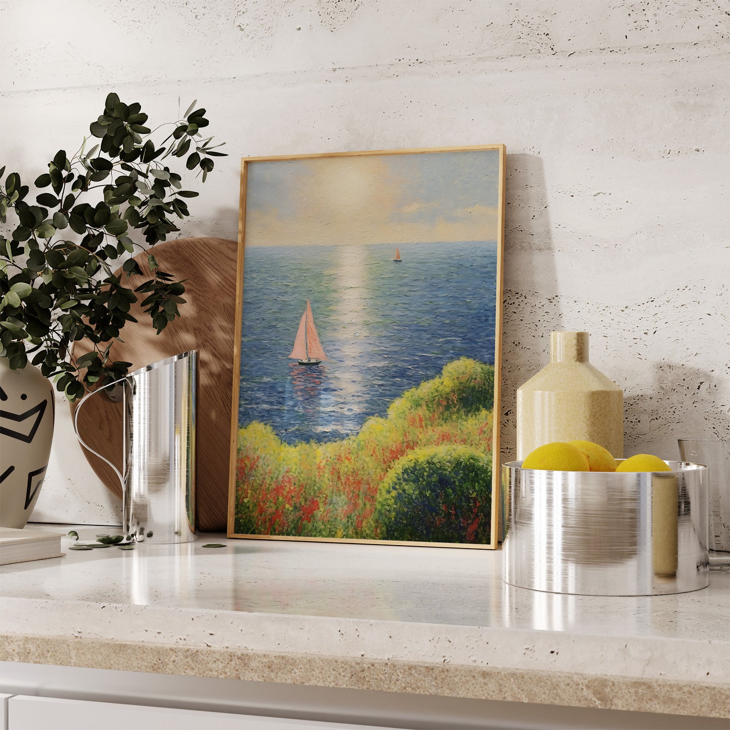 Landscape painting with sailboats on a kitchen counter beside decorative items.
