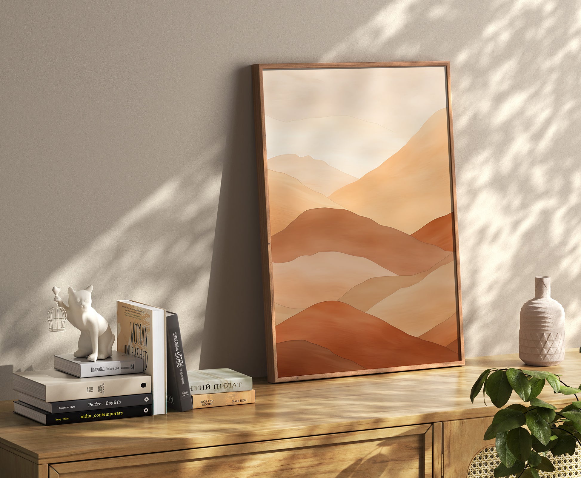 A framed abstract landscape artwork leaning against a wall on a wooden sideboard with decorative items.