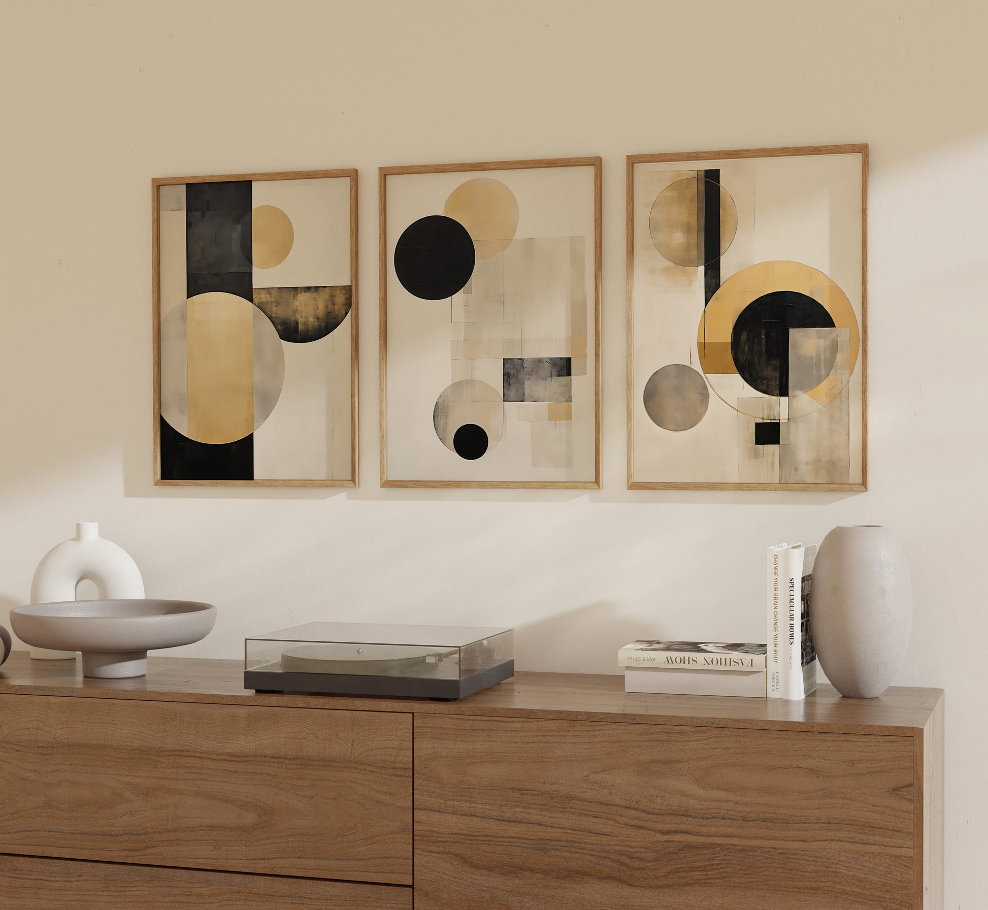 Three framed abstract art pieces on a wall above a wooden sideboard with decorative items.