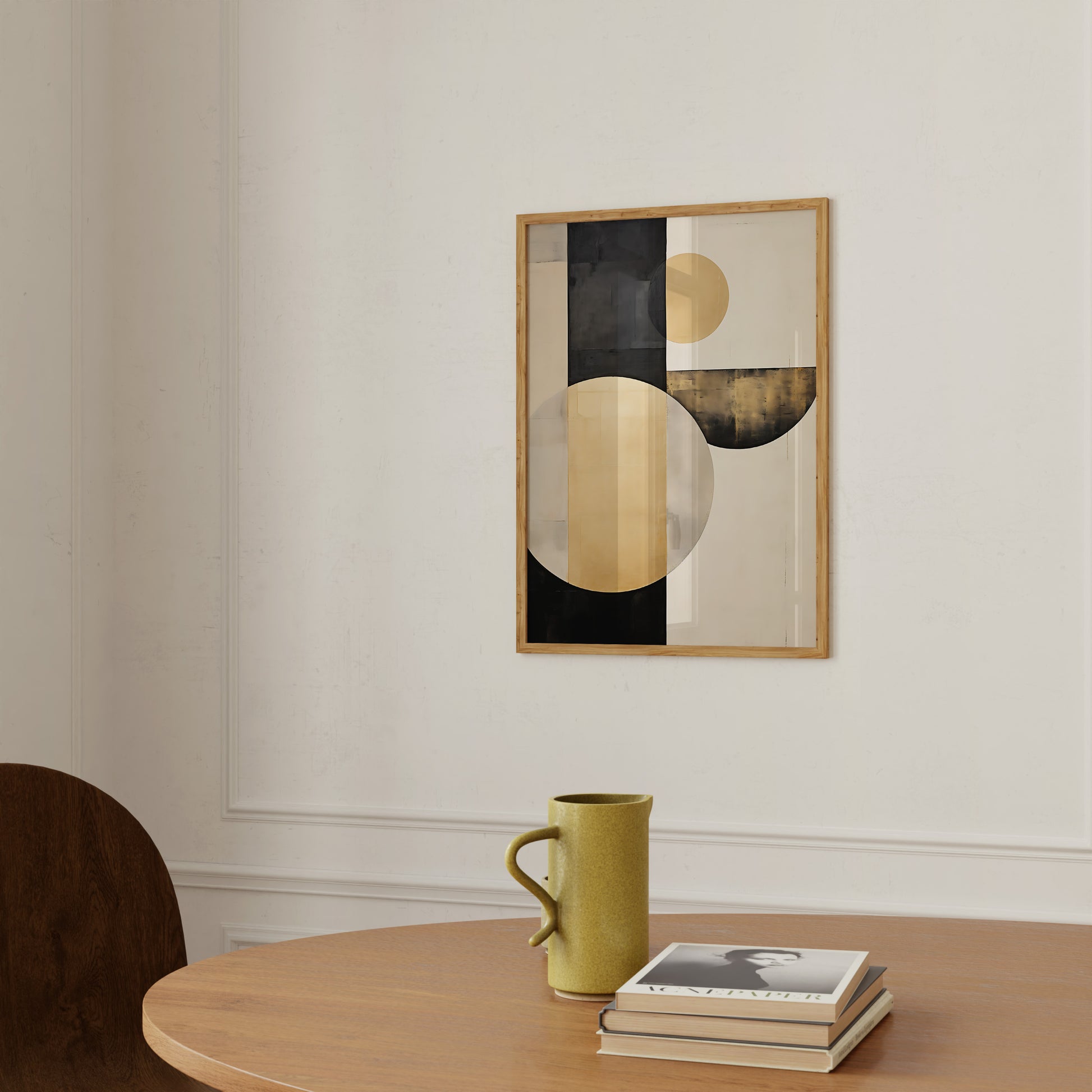 Modern abstract painting on a wall above a table with a mug and books.