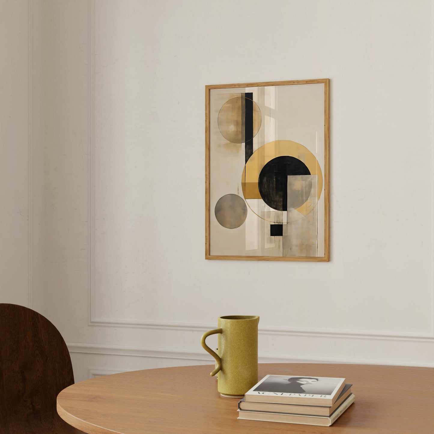 Modern abstract art on wall with a yellow mug and books on a wooden table.