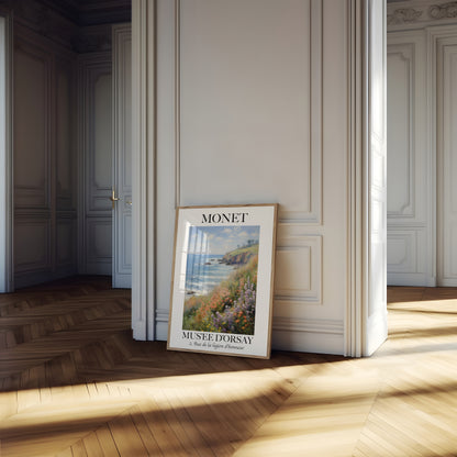 A framed Monet poster leaning against a wall in an elegant room with sunlight streaming in.