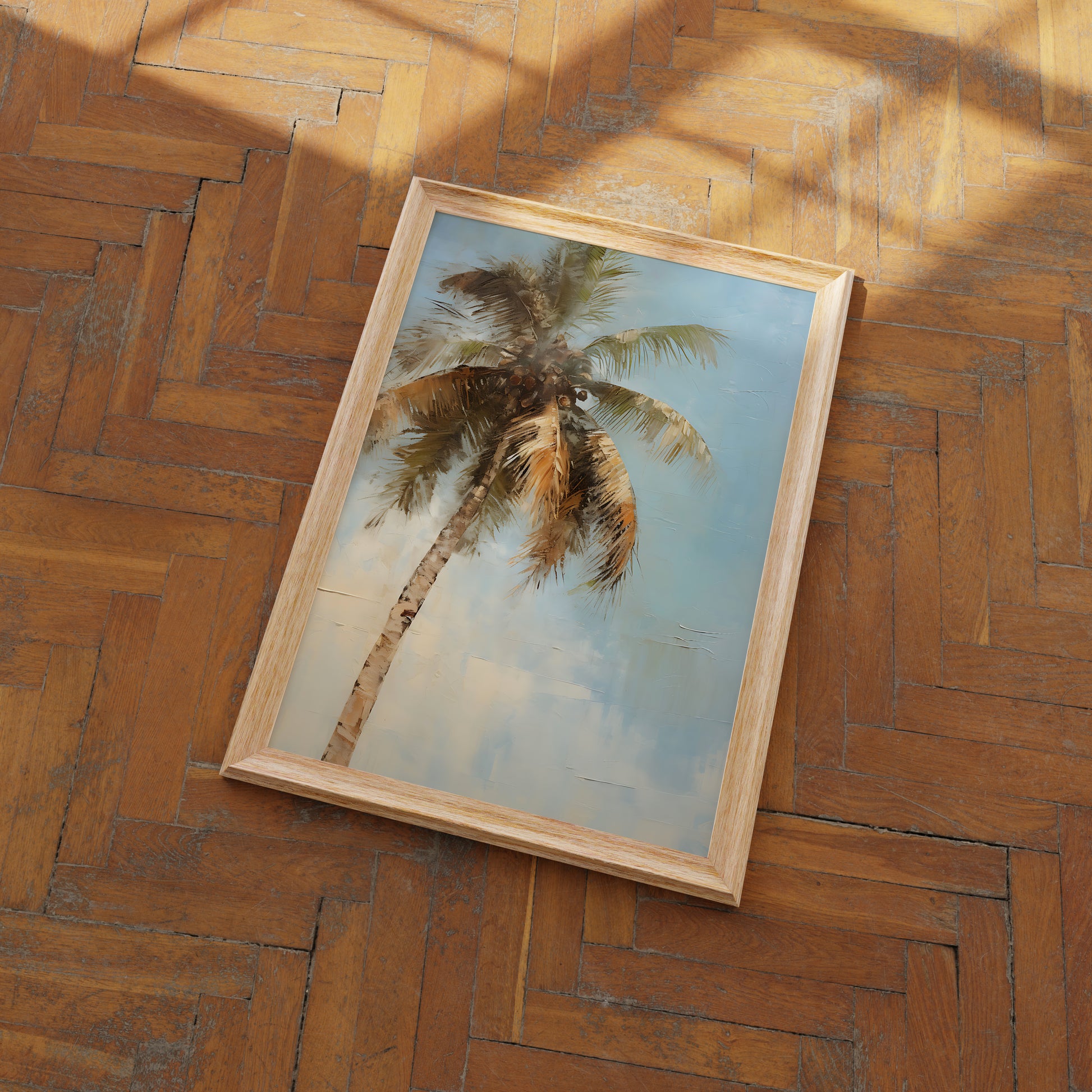 A framed painting of a palm tree on a wooden floor.