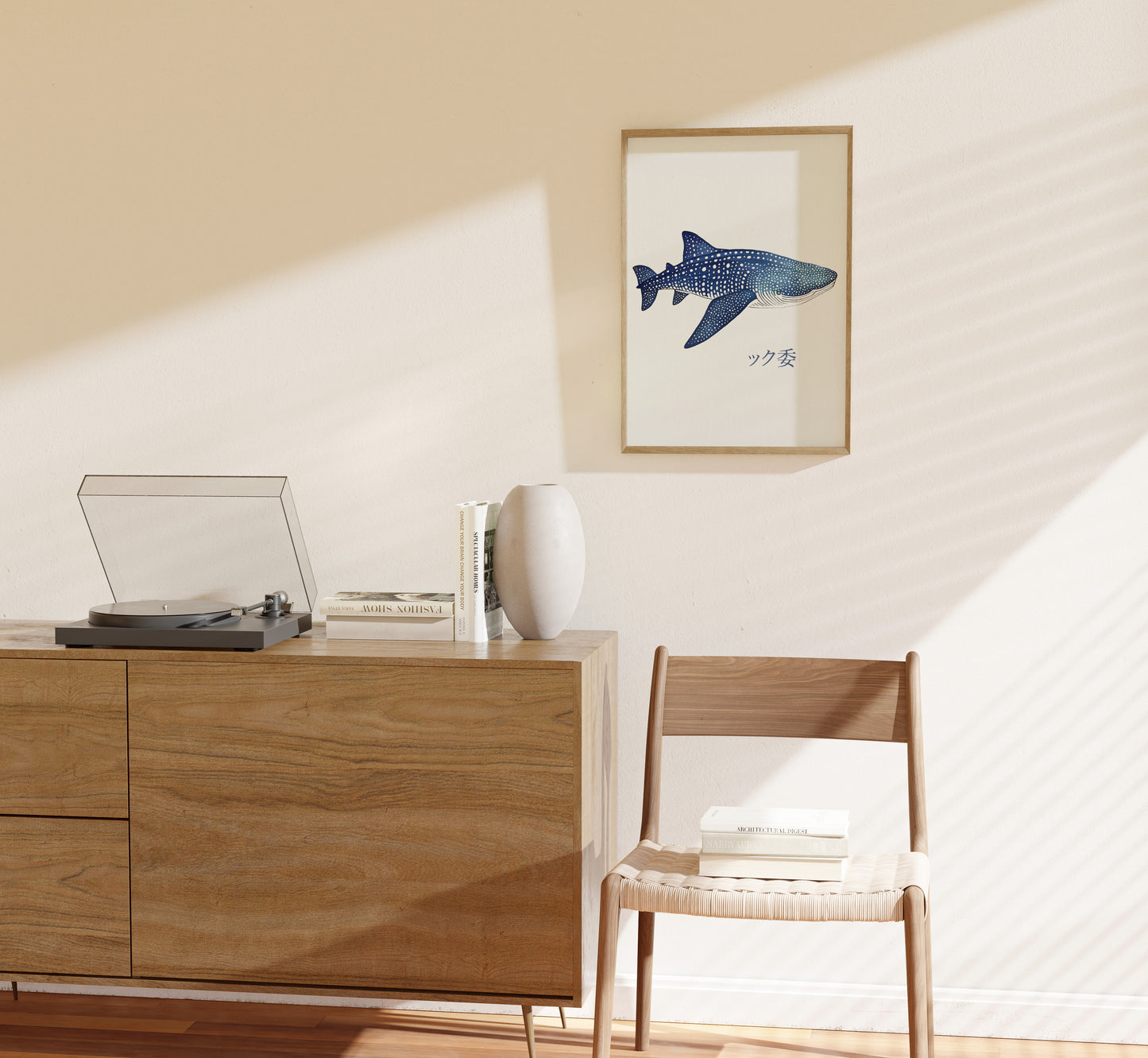 A cozy corner with a wooden cabinet, a record player, and a framed fish artwork on the wall.