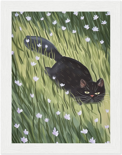 A painting of a black cat walking through a green field with white flowers, framed in wood.