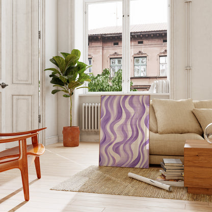 A modern living room with a large plant, stylish purple artwork, and a cozy beige sofa.