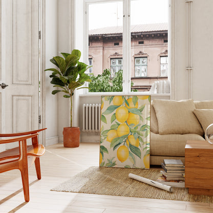 A cozy living room with a plant beside a sofa, and a lemon-patterned screen.