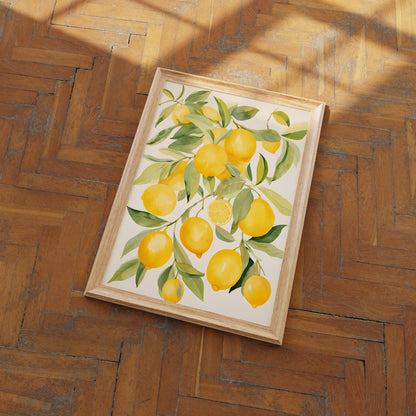 A framed painting of lemons on a branch lying on a herringbone wood floor.
