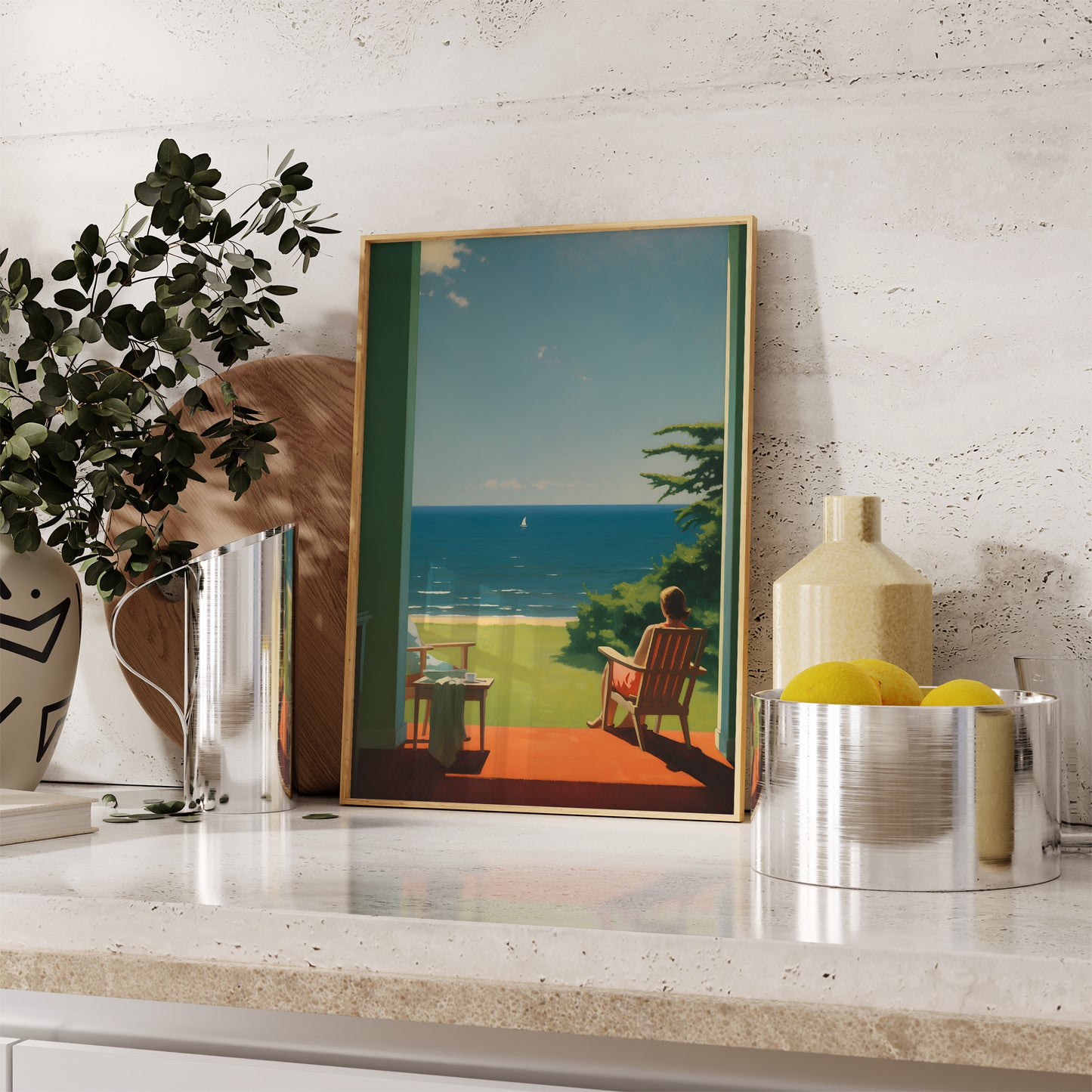 A framed painting of a seaside view on a shelf with decorative items.