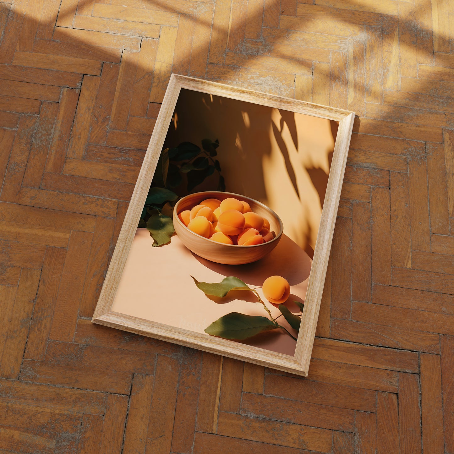 A wooden frame displaying a picture of apricots in a bowl on a table, with shadows of leaves.