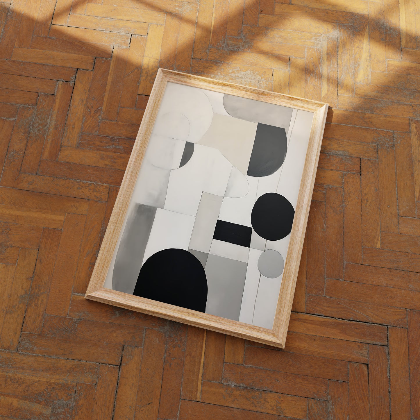 An abstract painting with geometric shapes on a wooden floor.