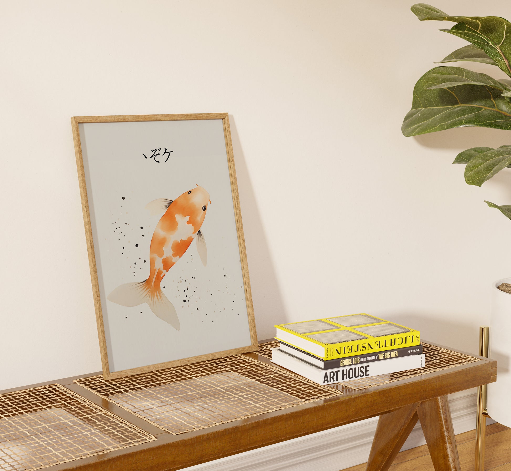 A framed koi fish painting on a shelf next to plant and stacked books.