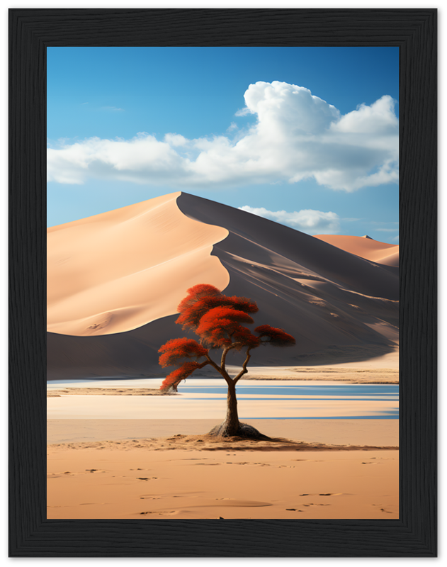 A framed image of a lone red tree in a desert with sand dunes and blue sky.