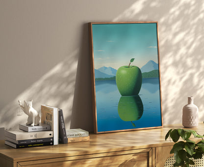 A framed poster of an apple reflected in water, on the floor leaning against a wall in a sunny room.