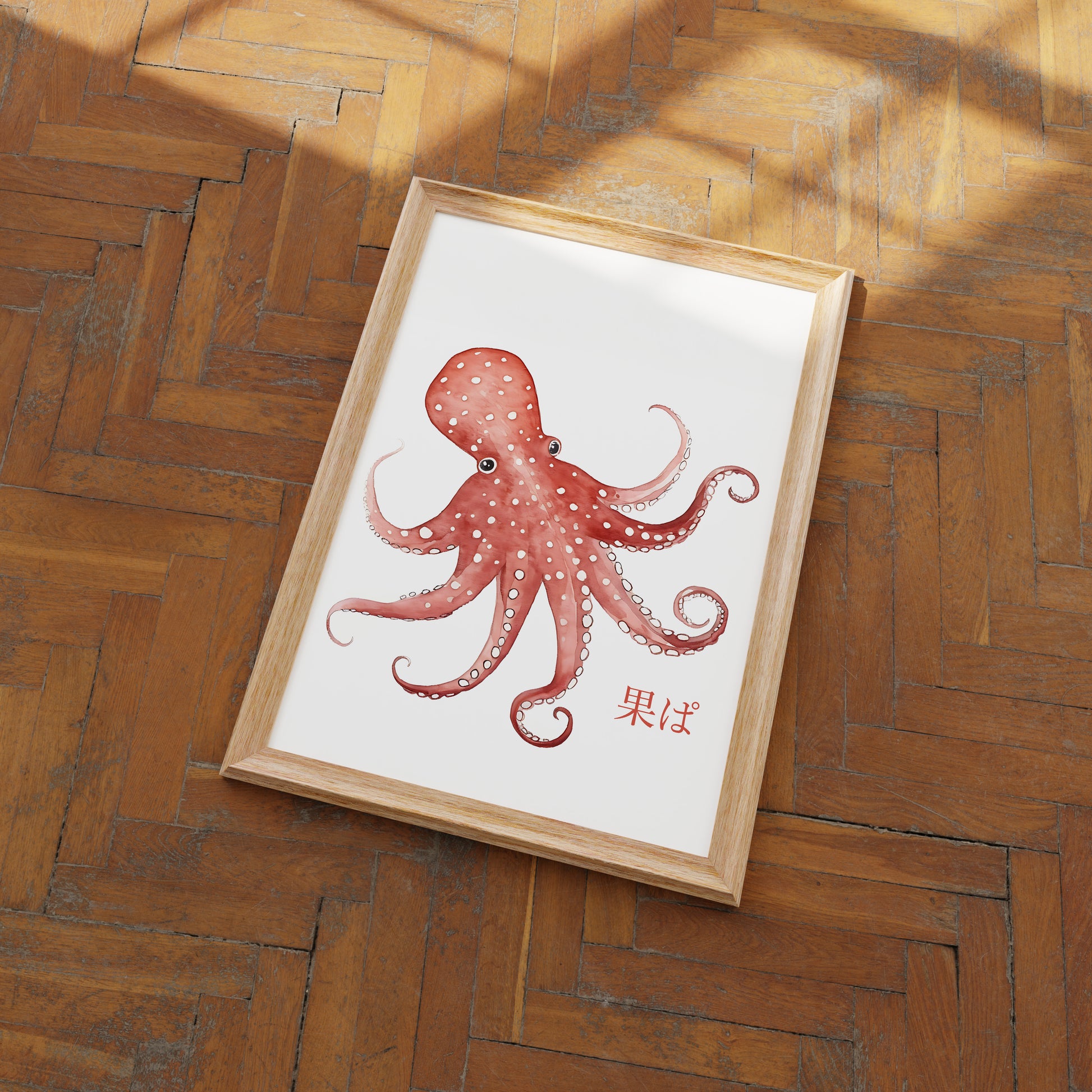 "Framed octopus illustration lying on a herringbone wood floor."
