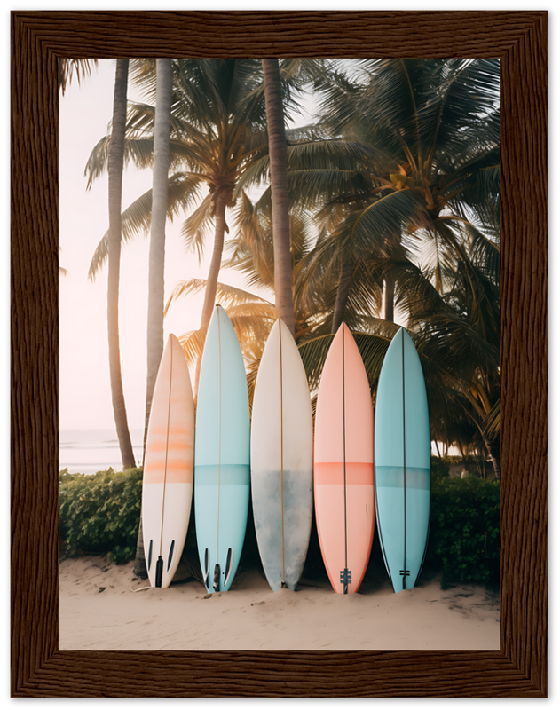 A row of surfboards leaning against a fence on a beach at sunset with palm trees in the background.