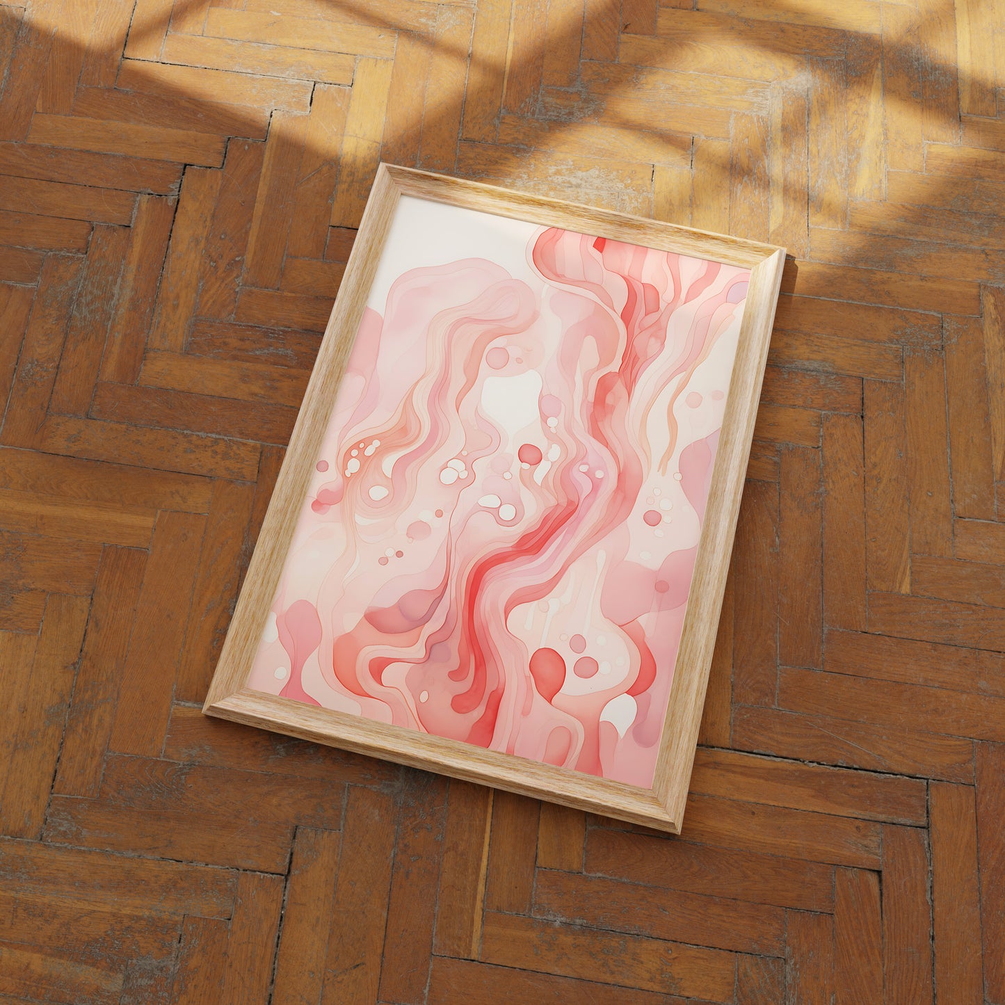 Abstract pink and white marbled art in a wooden frame on a herringbone floor.