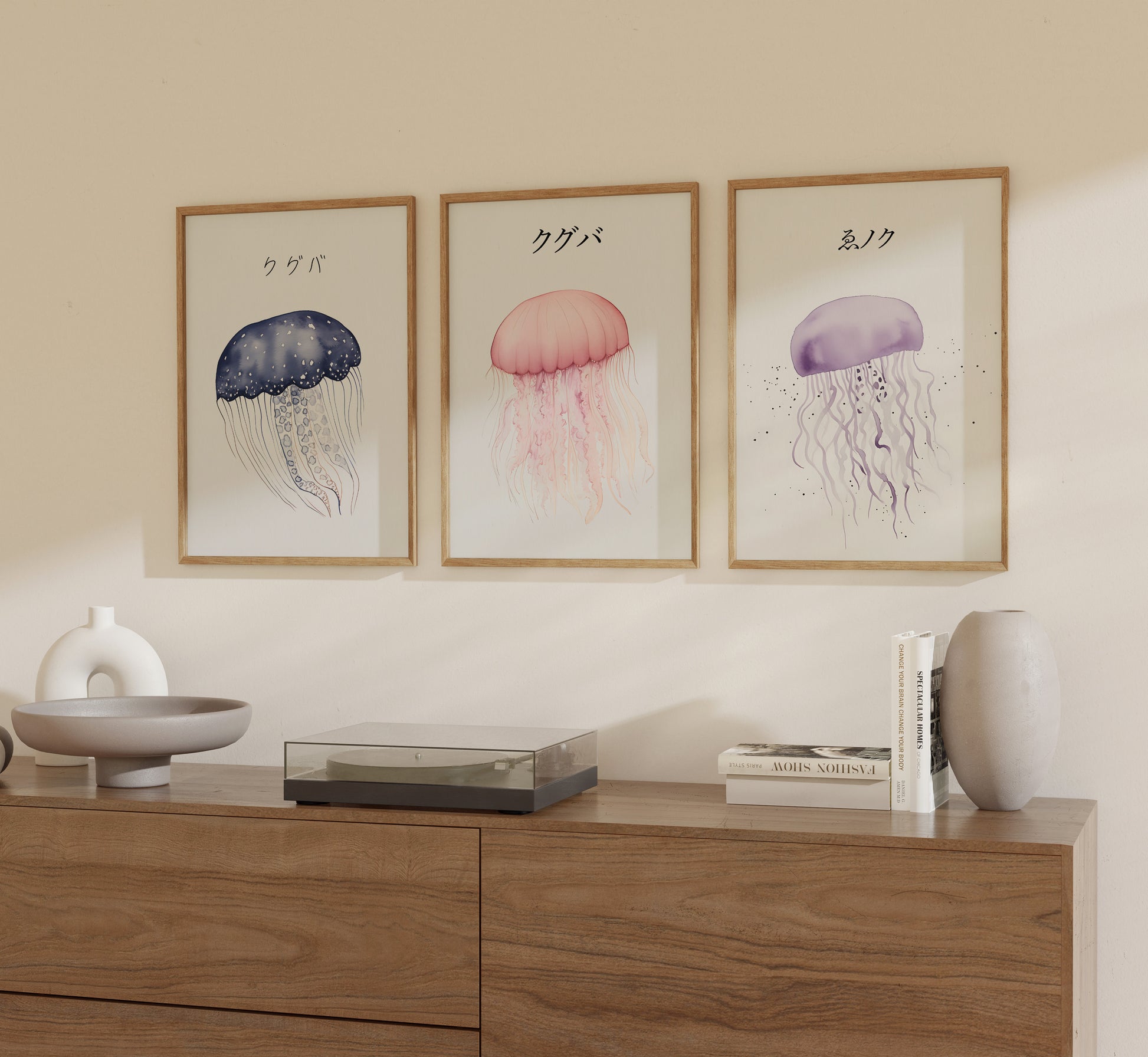 Three framed illustrations of jellyfish on a wall above a wooden sideboard.