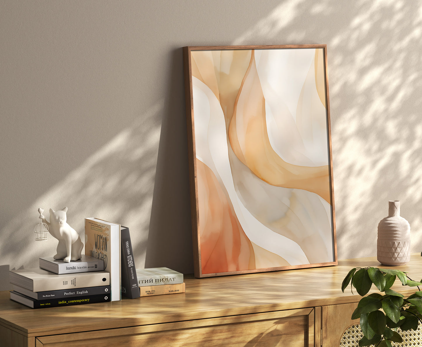 Modern abstract art in frame leaning against wall with books and decor on shelf.