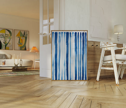 Modern living room with a blue and white striped canvas leaning against the wall.