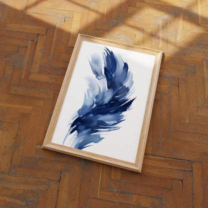 A framed abstract painting with blue strokes on a wooden floor.