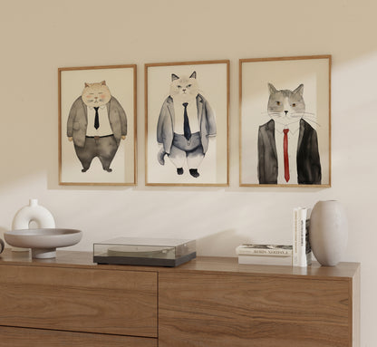 Three framed pictures of cats dressed in business suits on a wall.