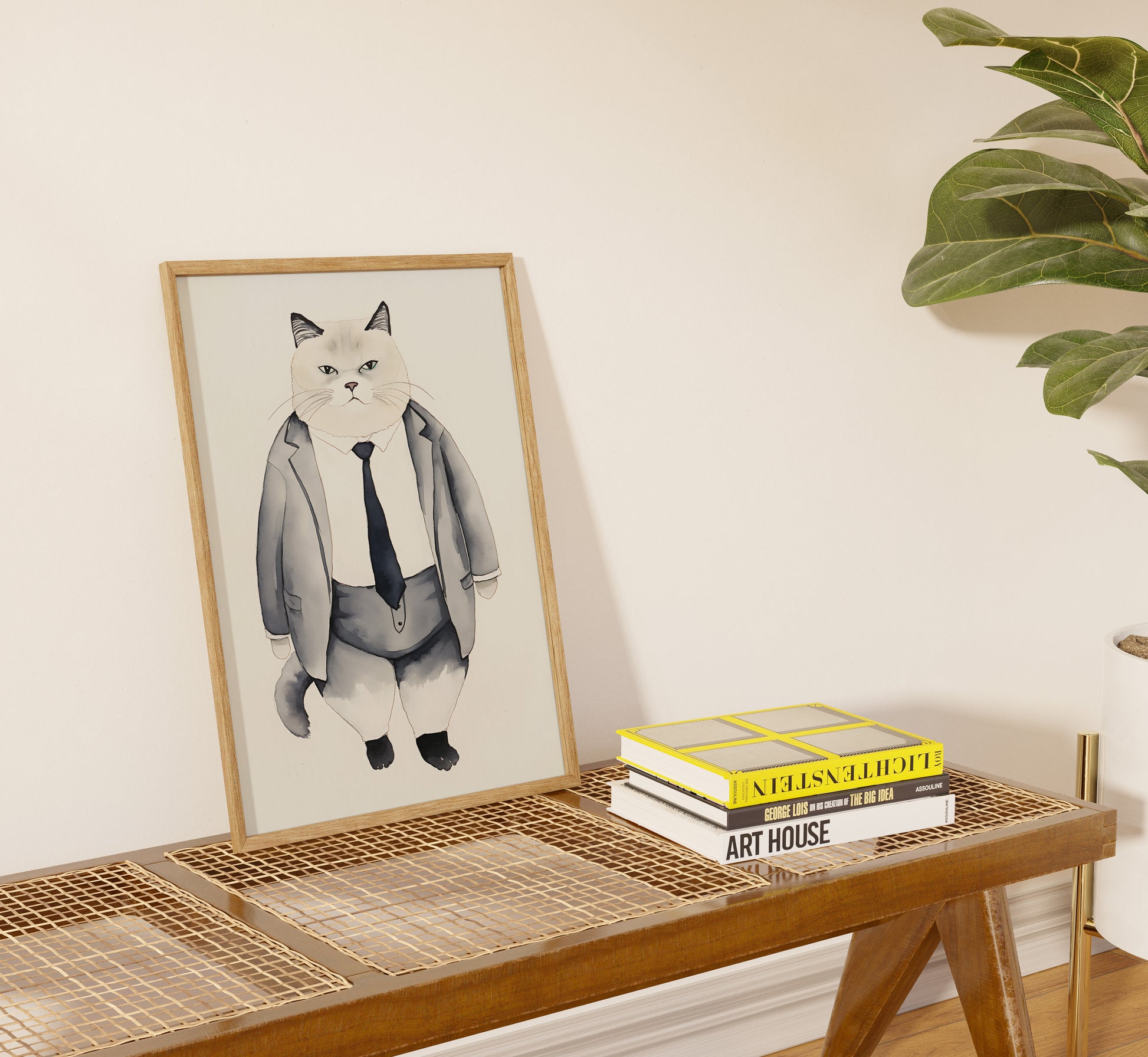 A framed illustration of a cat in a suit on a shelf beside books.