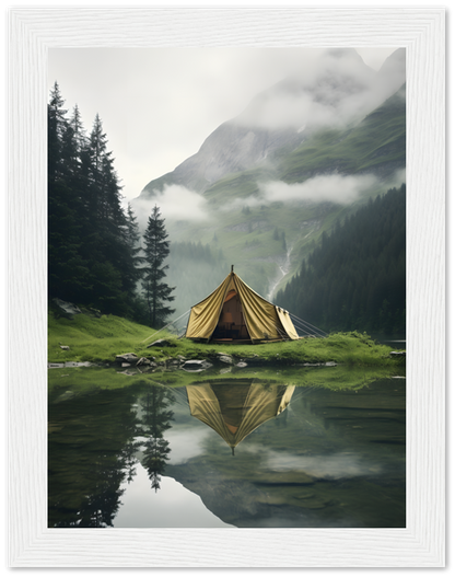 A tent reflected in a clear mountain lake surrounded by misty peaks.