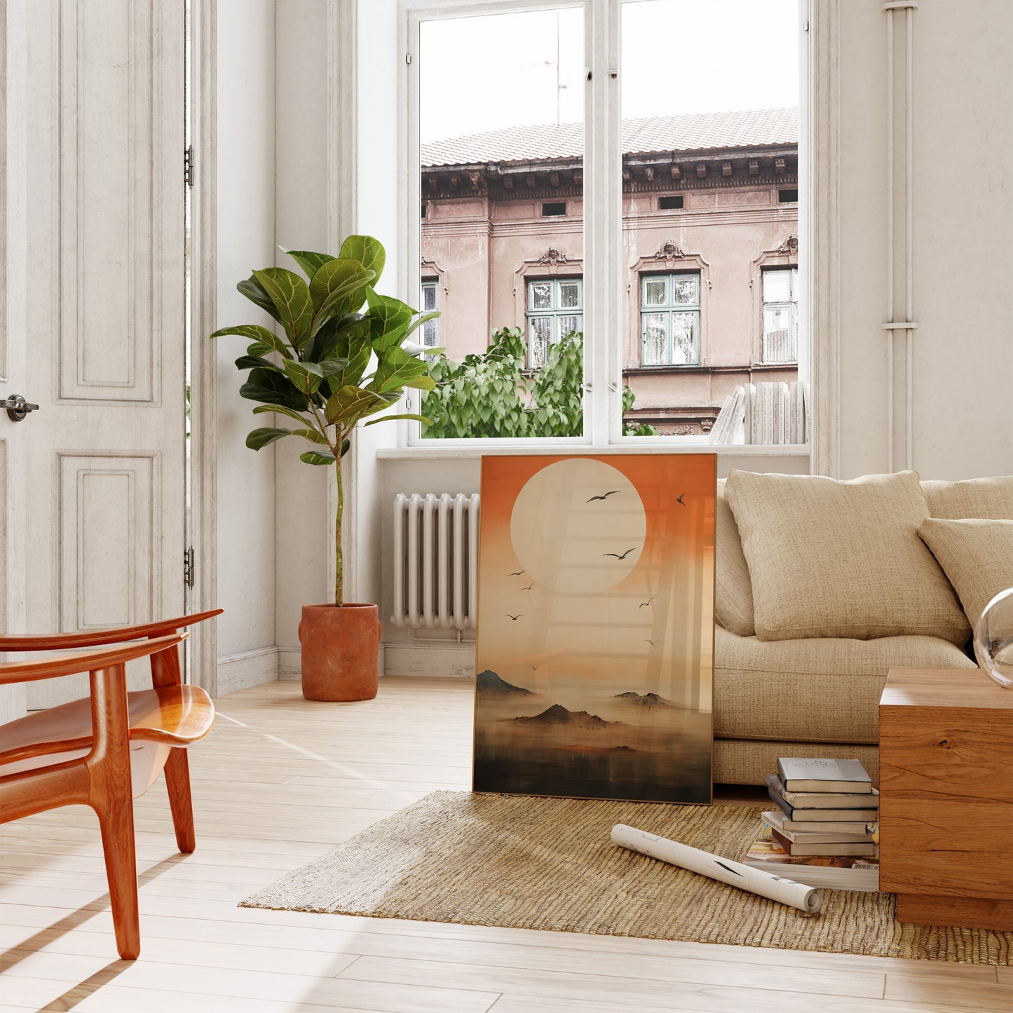 A cozy living room with a sofa, plants, and a scenic painting leaning against the wall.