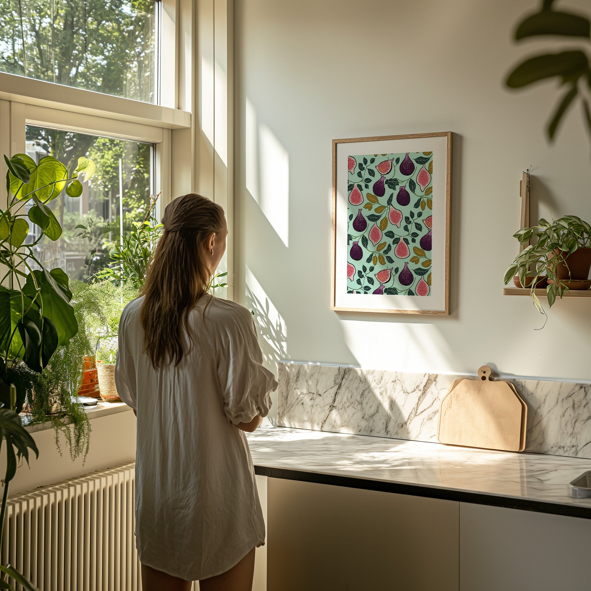 Woman in a white shirt gazing out a sunny window in a kitchen with plants.