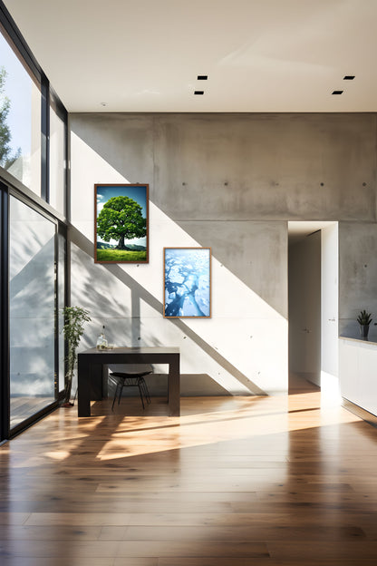 A modern interior with sunlight casting shadows from a staircase on a wooden floor, and artwork on the wall.