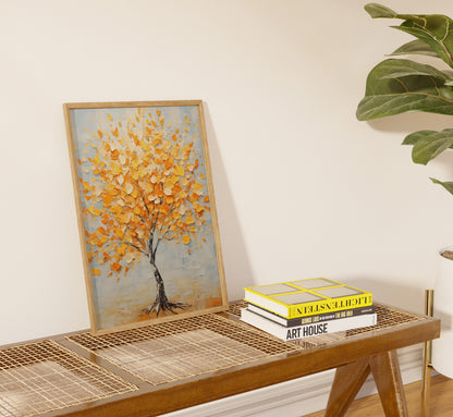 A painting of a tree with autumn leaves leaning against a wall above a table with books.