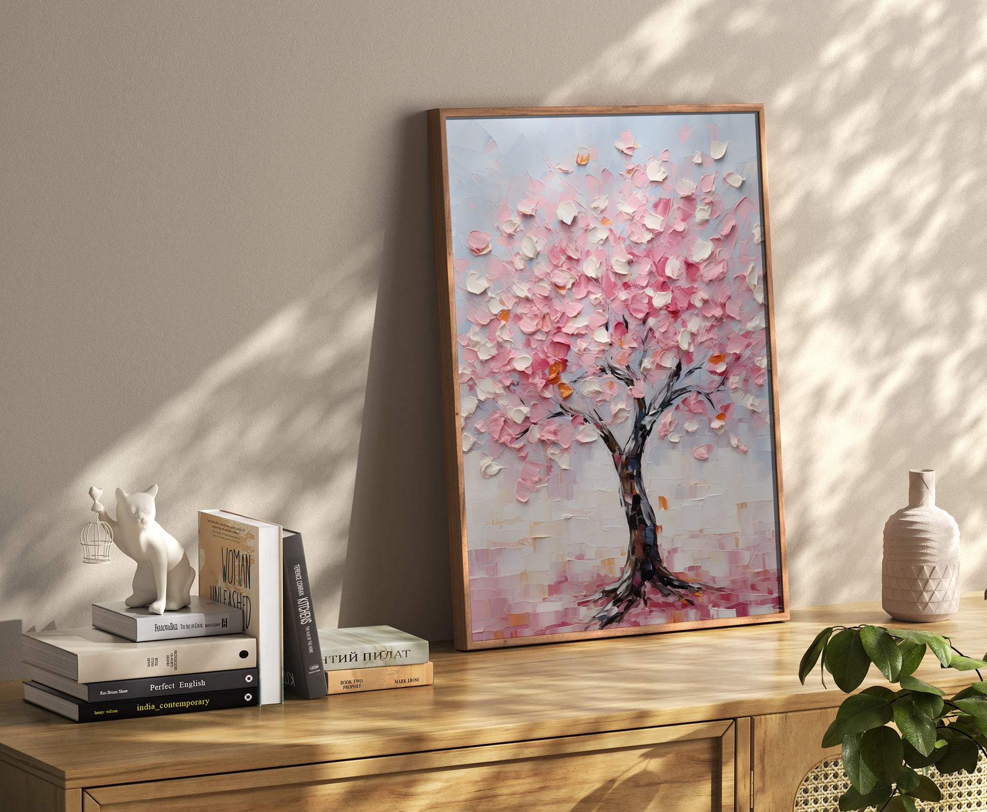 Painting of a cherry blossom tree in a room with books and decorative items.