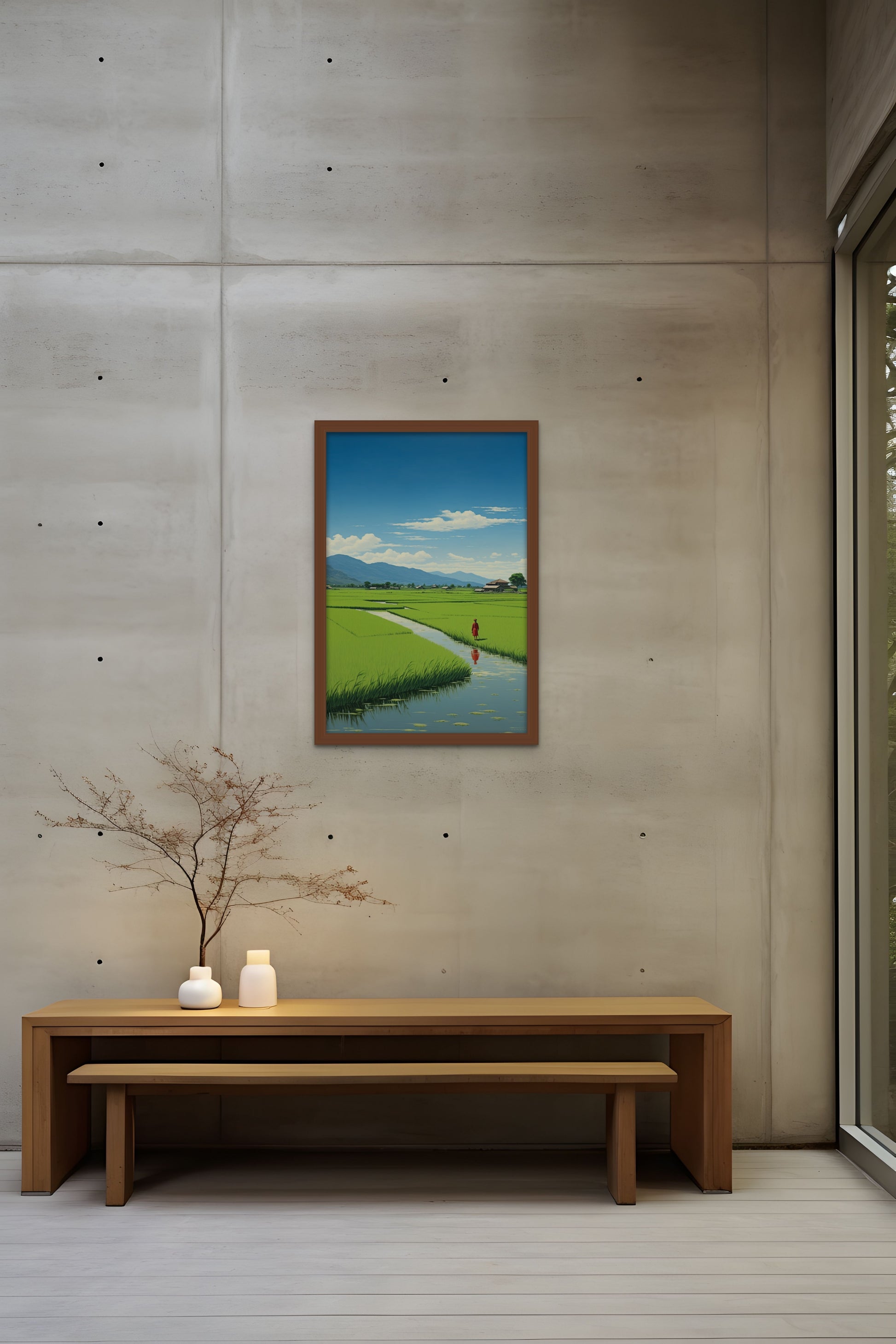 Painting of a rural landscape on a concrete wall above a bench with a decorative plant and candles.
