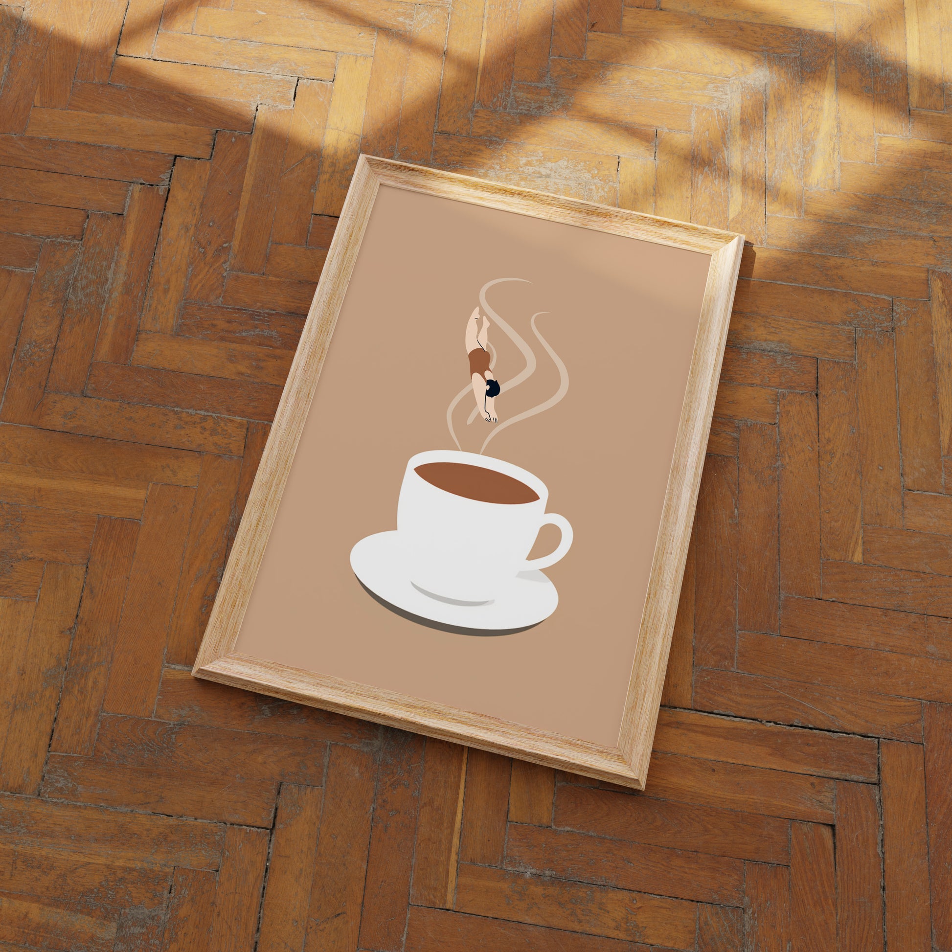 A framed picture of a coffee cup on a wooden floor.
