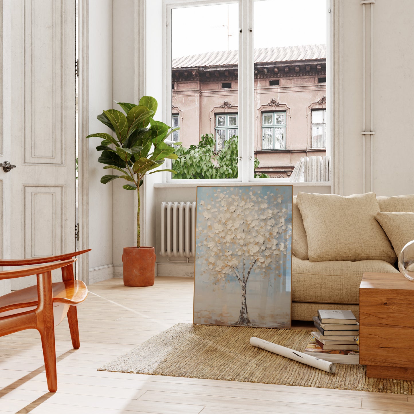 A cozy living room with a couch, artwork, and a potted plant by an open door.