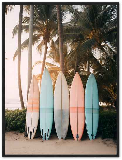 Five surfboards lined up against palm trees on a beach at sunset.