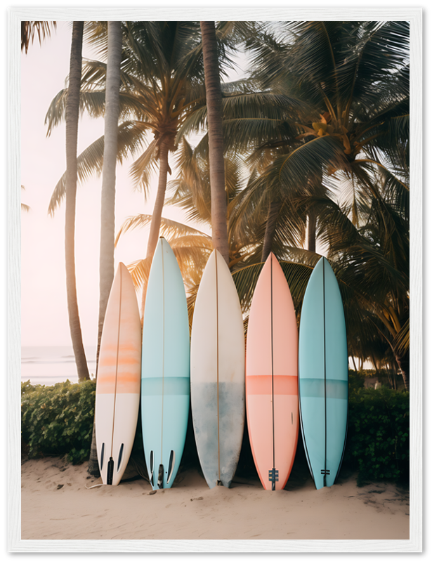 Five surfboards leaning against palm trees on a beach at sunset.