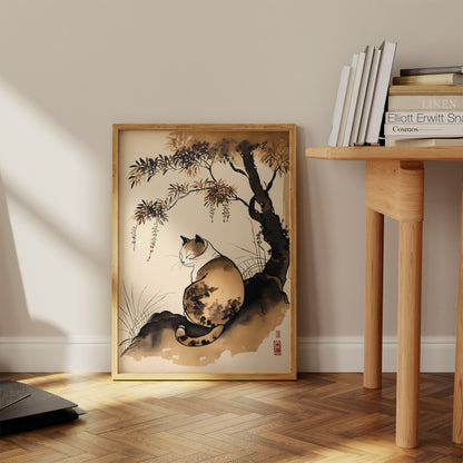 A framed painting of a cat under a bamboo tree in a room with books.