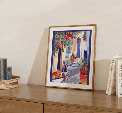 Framed artwork of a colorful balcony scene with plants and a cat on a wooden shelf.