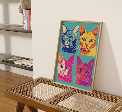 Colorful pop art style portrait of four cats displayed in a frame on a floor easel.