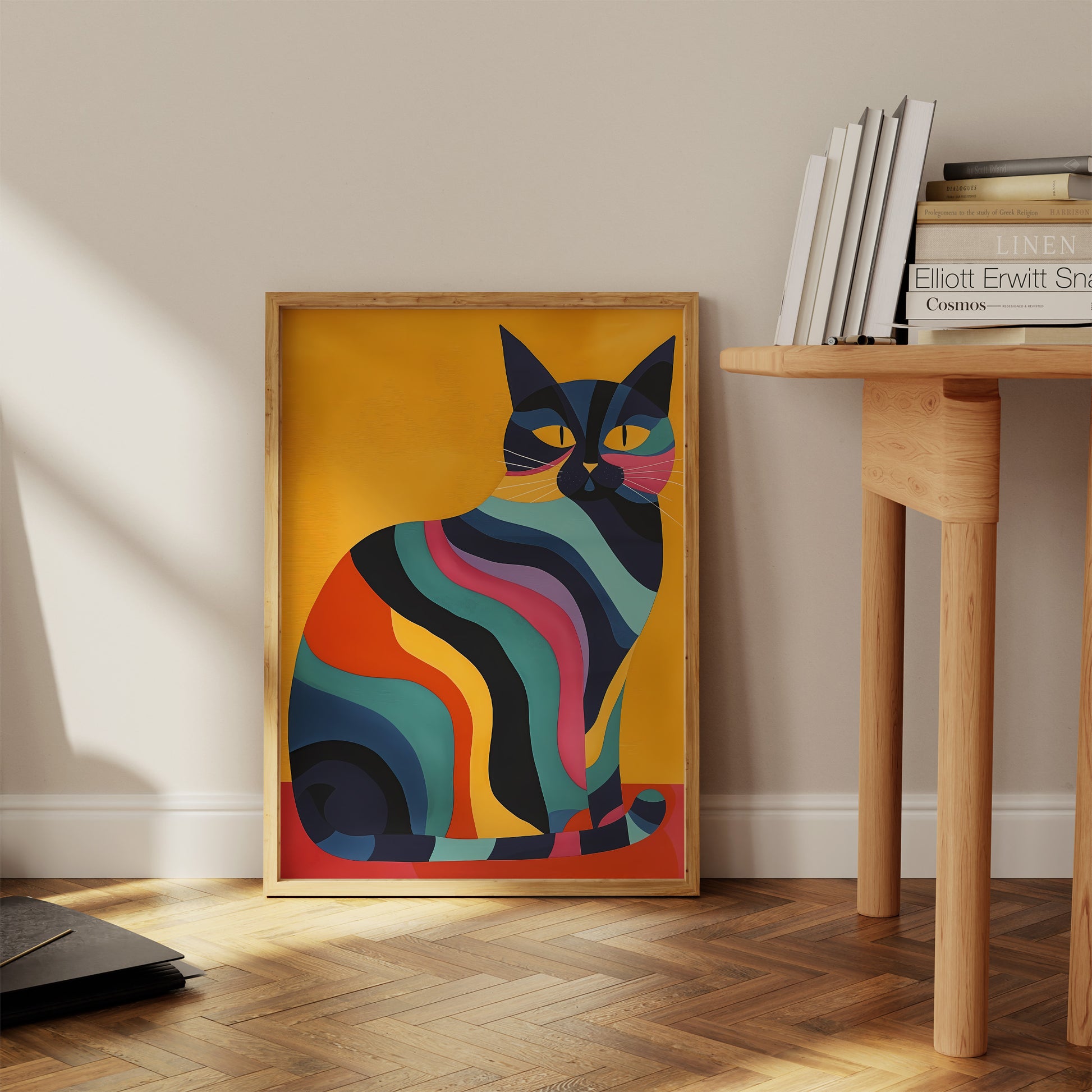Colorful abstract cat painting leaning against a wall in a room with books and furniture.