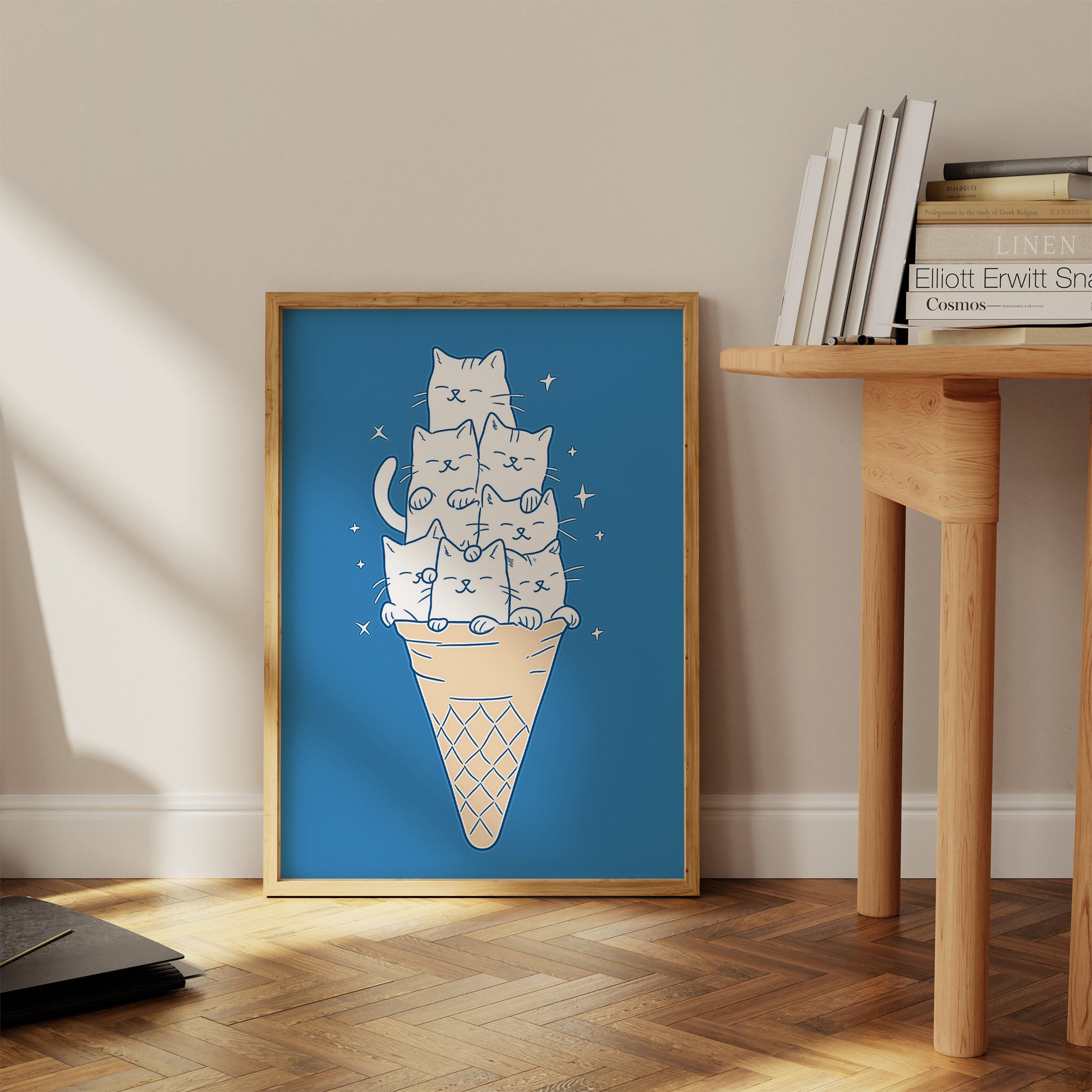 Illustration of cats stacked in an ice cream cone, framed and placed against a wall.
